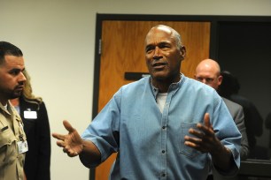 O.J. Simpson reacts after learning he was granted parole at Lovelock Correctional Center in Lovelock, Nev.
