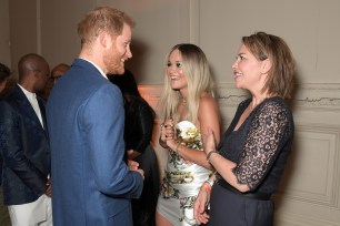 Rita Ora and her mother chat with Prince Harry before the event.