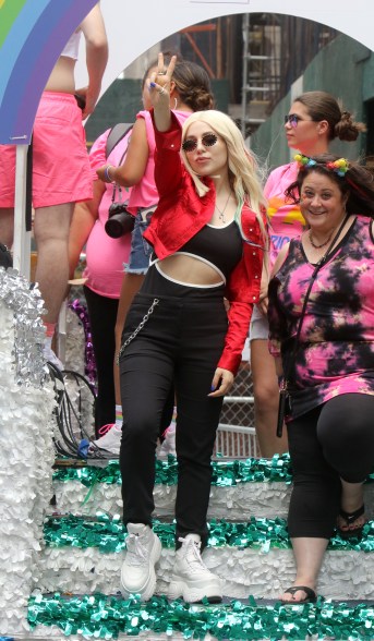 Ava Max paired a red bolero jacket with black high waisted pants and a sports bra.