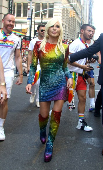 Donatella Versace rocked a rainbow sequined dress and thigh high boots.