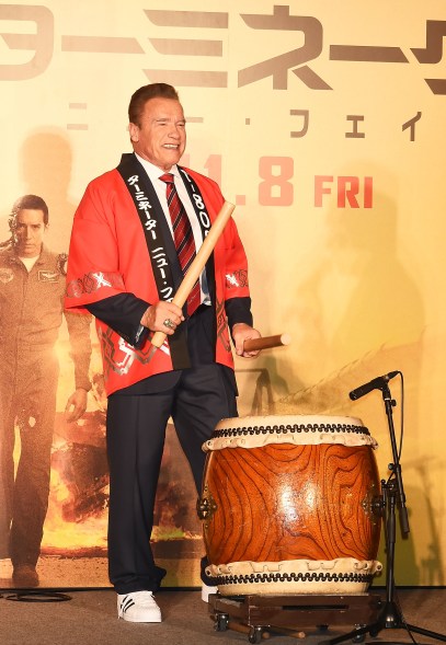 Arnold Schwarzenegger tests out his percussion skills at the Japan premiere of "Terminator: Dark Fate."