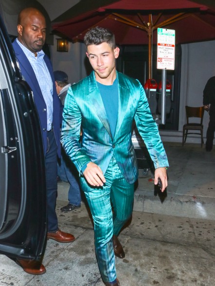 Nick Jonas wears a teal suit out in Los Angeles.