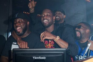 Bobby Metelus, Dwyane Wade, Udonis Haslem and DJ Irie are seen during Wade's jersey retirement celebration