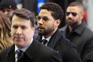 Jussie Smollett (center) arrives at the Leighton Criminal Courthouse today.