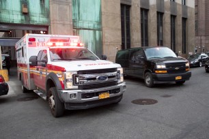 An ambulance carrying Harvey Weinstein is escorted from a Manhattan courthouse