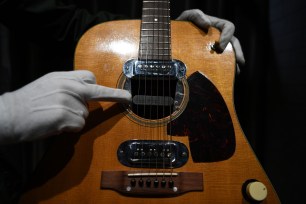 Co-owner of Julien's Auctions, Martin Nolan displays the guitar used by musician Kurt Cobain during Nirvana's famous MTV Unplugged in New York concert in 1993, at the Hard Rock Cafe Piccadilly Circus in central London on May 15, 2020, prior to the auction of the guitar in Beverly Hills in June.