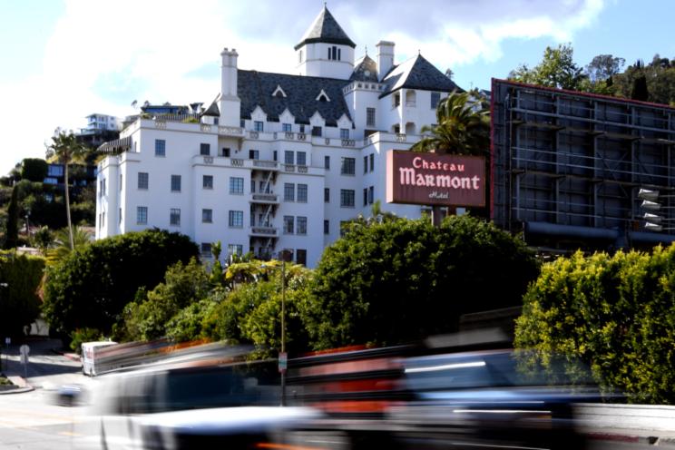 Cars drive past the Chateau Marmont