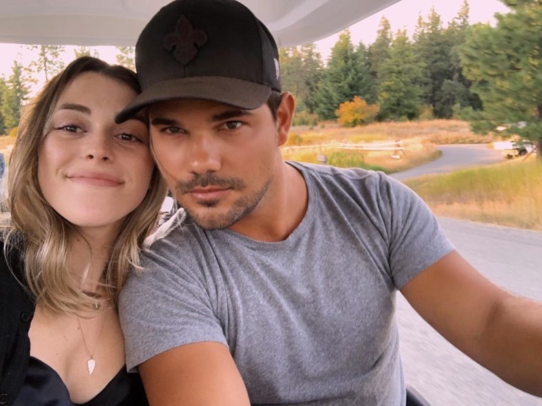 Taylor Lautner and his girlfriend Tay Dome take a selfie in a golf cart.