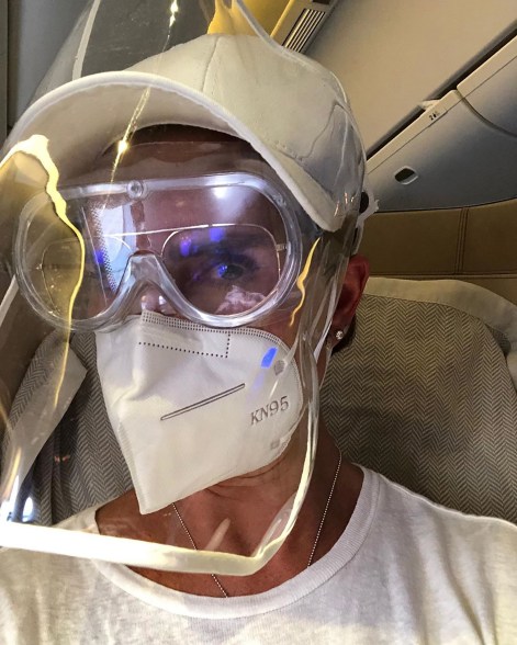 Brooke Shields gears up on a flight to London to protect herself from the coronavirus.