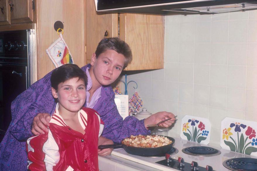 Joaquin and River Phoenix cooking at their home in Los Angeles, California, US, circa 1985.