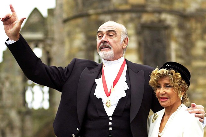 Sir Sean Connery, with wife Micheline, right, pose for photographers after he was formally knighted by the Britain's Queen Elizabeth at Holyrood Palace in Edinburgh.