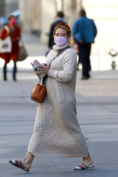 Hilary Duff wears a sweater dress and gingham mask in New York.