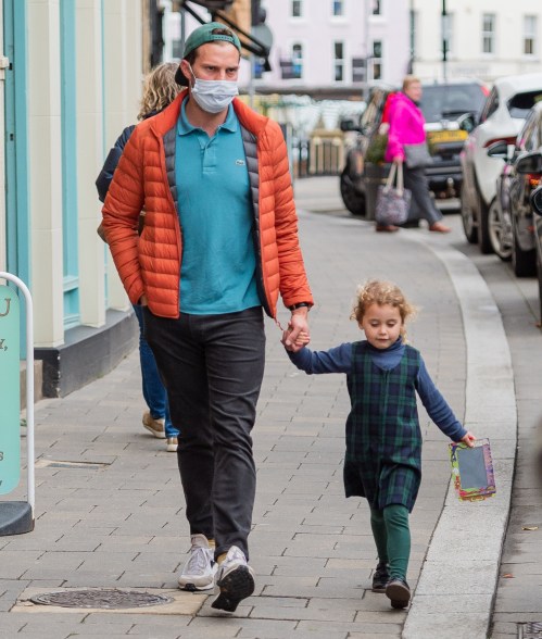 Jamie Dornan holds hands with his daughter while out in the UK.