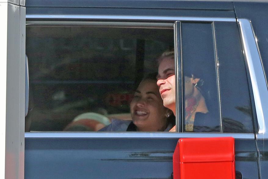 Demi Lovato and Mod Sun ride in an SUV