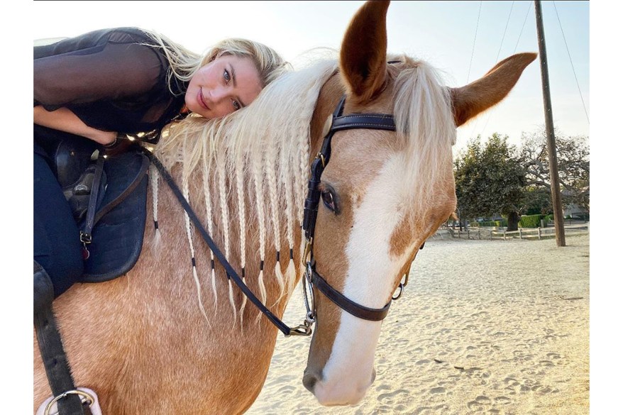 Amber Heard snuggles up to her noble steed, Arrow.