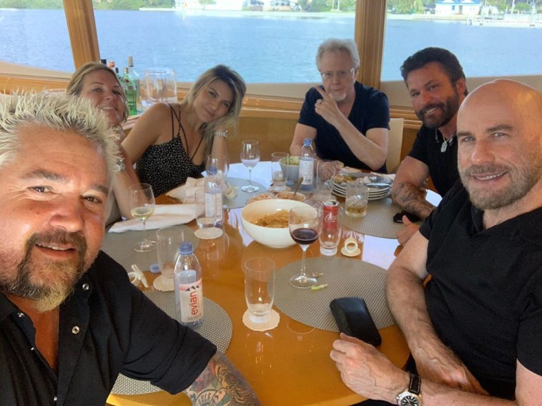 John Travolta grabs lunch with Guy Fieri and friends by the water.