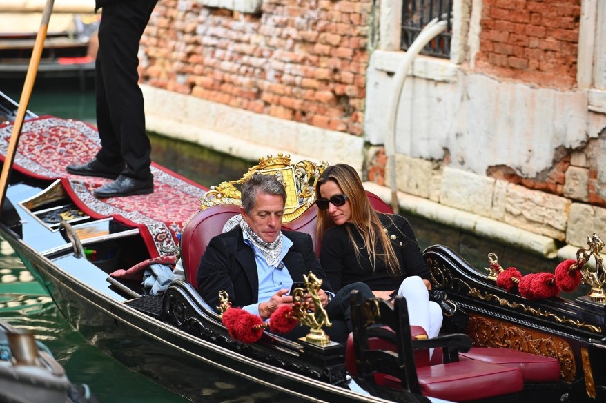 Hugh Grant can't get off his phone, even during a romantic gondola ride with his wife, Anna Elisabet Eberstein, in Venice, Italy.