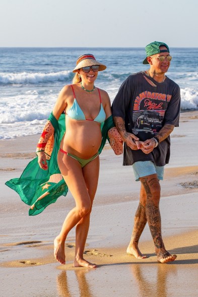 Pregnant Jessica Hart frolics on the beach with boyfriend James Kirkham in Cabo San Lucas, Mexico.