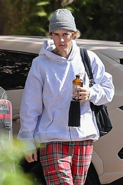 Justin Bieber enjoys a Health-Ade Kombucha while arriving at a music studio.