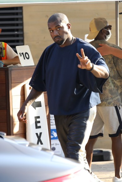 Kanye West flashes the peace sign after getting lunch in Malibu.