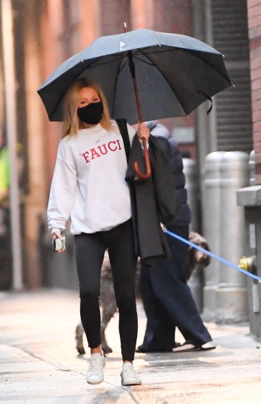 Kelly Ripa rocks a "Fauci" sweatshirt as she braves the rain in New York.