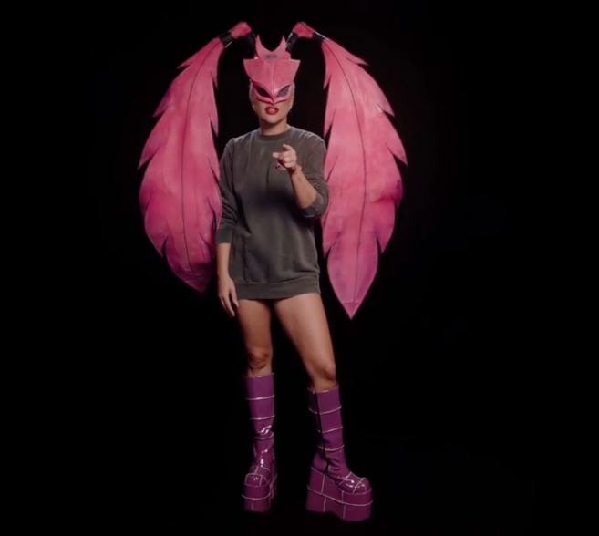 Lady Gaga in a "Chromatica" sweatshirt and "Stupid Love"-style pink feather mask.