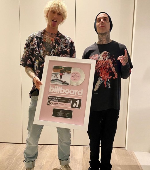 Machine Gun Kelly and Travis Barker celebrate their Billboard #1 song with a framed plaque.