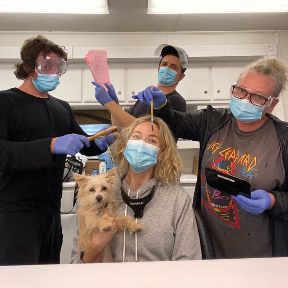 Naomi Watts wears a mask as her and her team get her ready for filming.