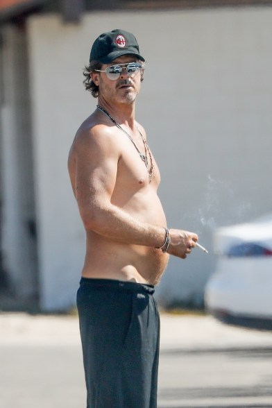 Robin Thicke takes a break on the beach in Malibu in a pair of low rise shorts and sunglasses.