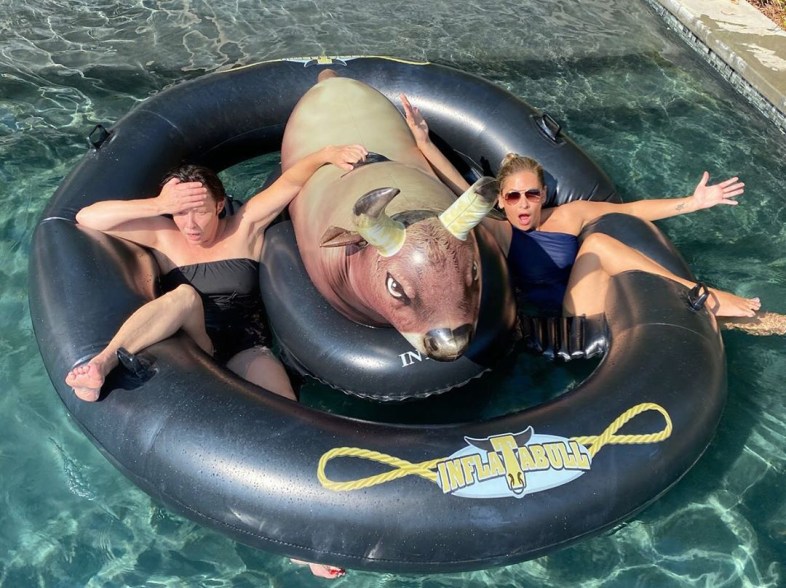 Sarah Michelle Gellar and Shannen O'Doherty are exhausted after trying to ride an inflatable bull in the pool