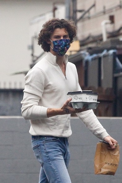 Shawn Mendes shows off his curly hair while picking up some coffee.