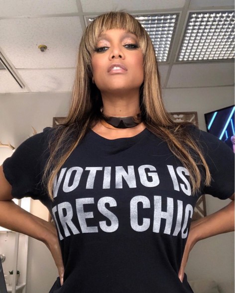 Tyra Banks says "Voting is Tres Chic" in her statement t-shirt.