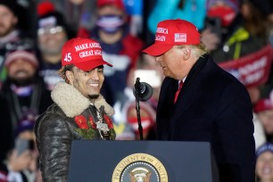 President Donald Trump brings rapper Lil Pump to the podium during a campaign event in Grand Rapids, Michigan.
