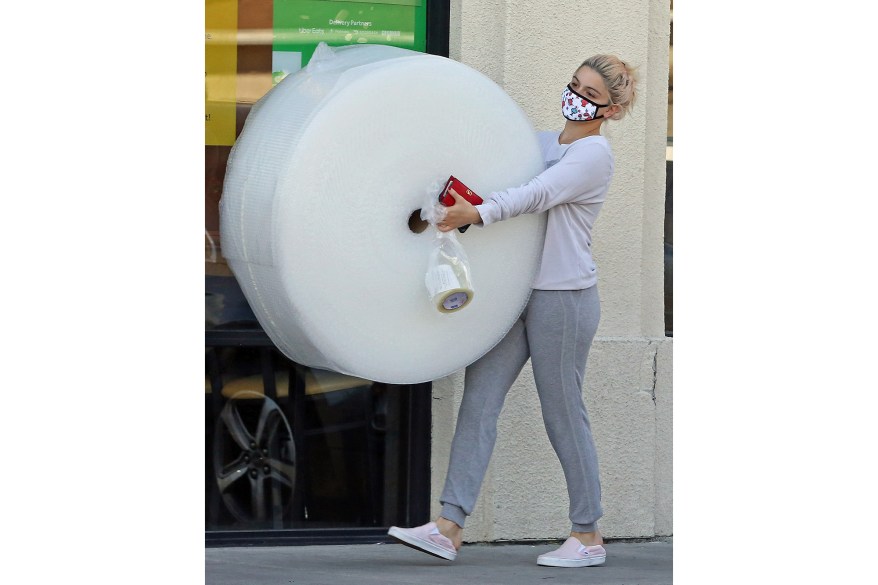 Ariel Winter carries a large roll of packing materials and tape in LA.