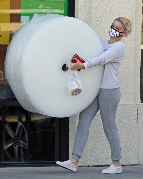 Ariel Winter gets ready for a move with a huge roll of bubble wrap.