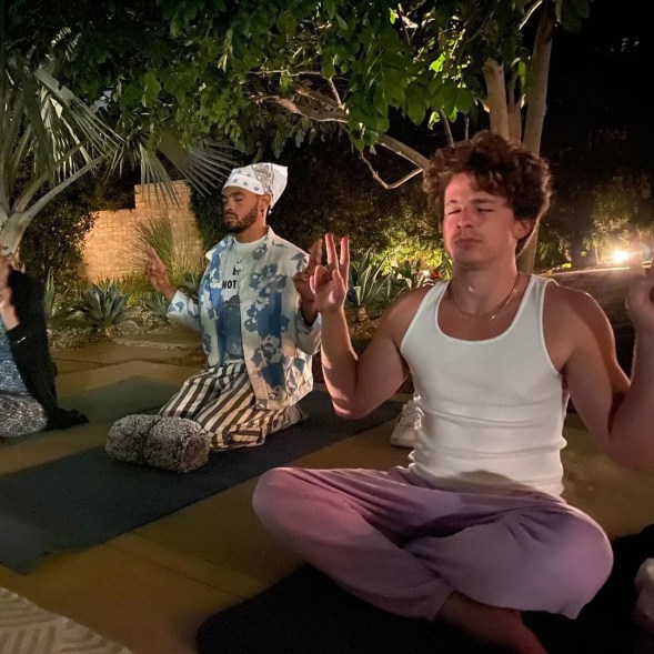 Charlie Puth meditates with a friend.