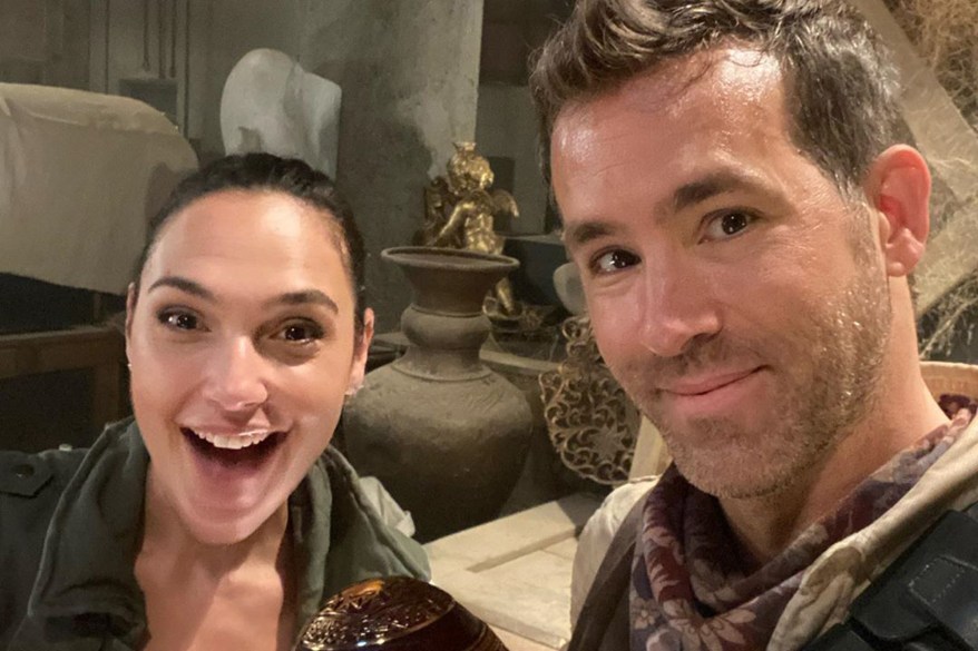 Gal Gadot and Ryan Reynolds pose on the set of their new movie "Red Notice."