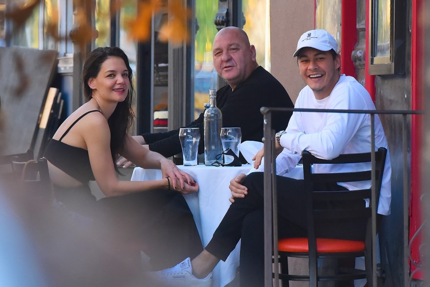 Katie Holmes, boyfriend and restaurant owner Emilio Vitolo Jr. (right) and his dad, Emilio Vitolo Sr., dine outside their restaurant Emilio's Ballato in Soho.