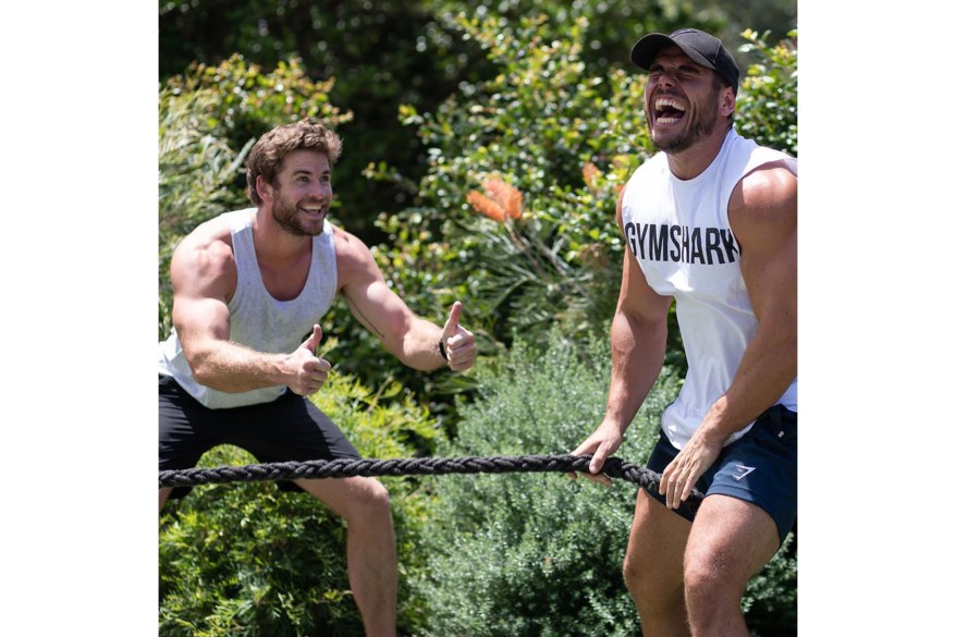 Liam Hemsworth (left) motivates his "gym buddy" Ross Edgley during a workout.