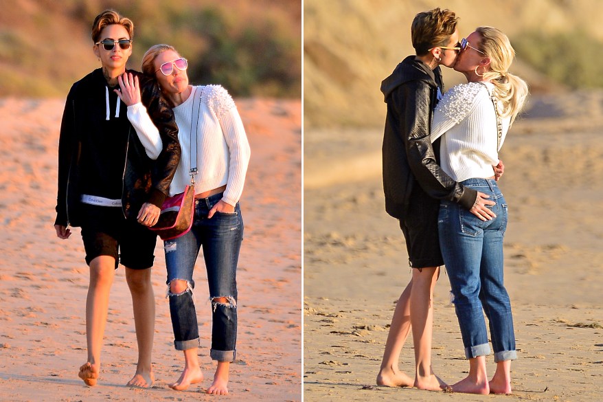 Newly out “Real Housewives of Orange County” cast member Braunwyn Windham-Burke (right) kisses her girlfriend on Laguna Beach.