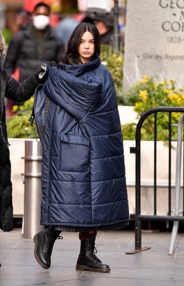 Hailee Steinfeld keeps warm as she films "Hawkeye" in Times Square.