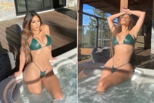 Kim Kardashian poses in a hot tub wearing a leather bikini.