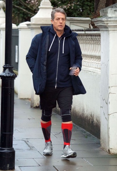 Despite the cold weather, Hugh Grant pairs shorts with knee-high socks and sneakers in London.