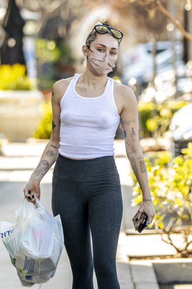 Miley Cyrus goes braless, but not maskless, to Rite Aid in Calabasas, Calif., to pick up some things.