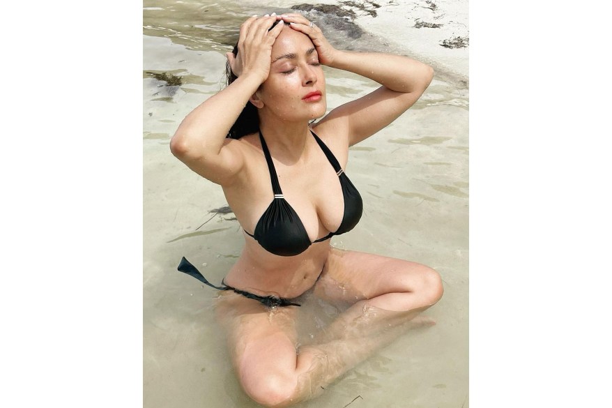 “We need to keep our cool,” says Salma Hayek while relaxing on a beach.