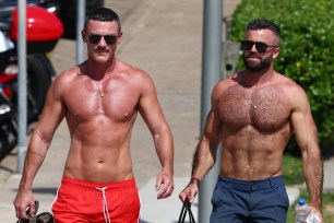 Luke Evans and a friend walk through the streets of Sydney.