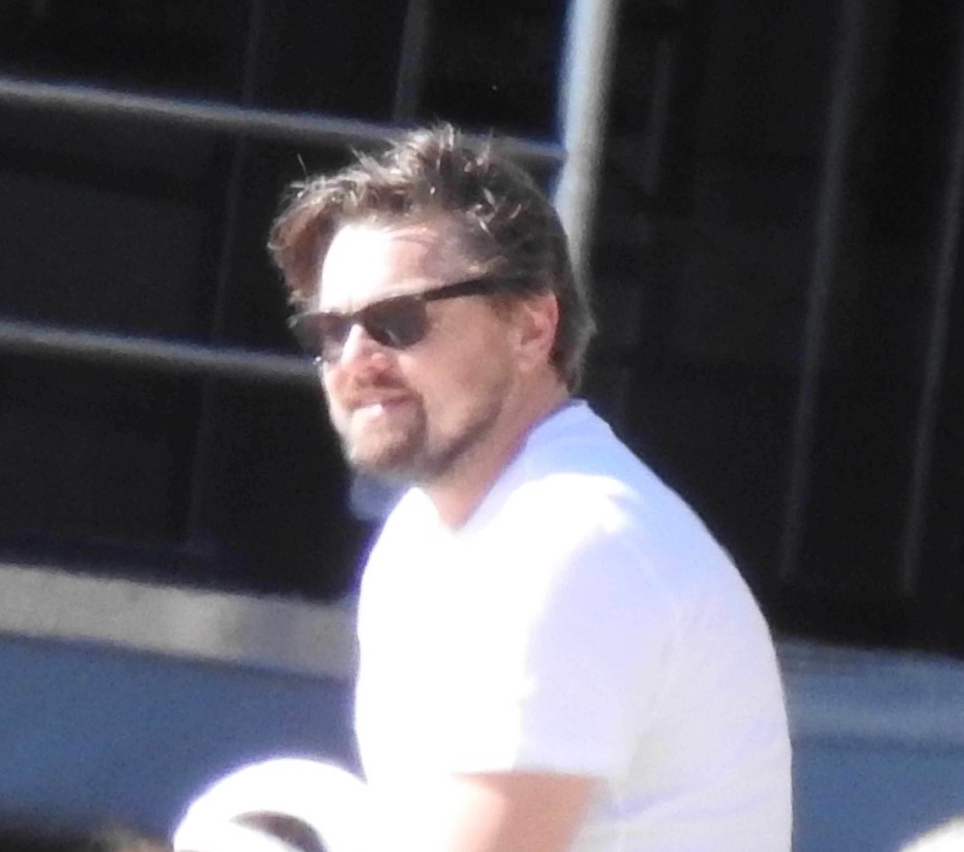 Leonardo DiCaprio hangs at the beach with friends.