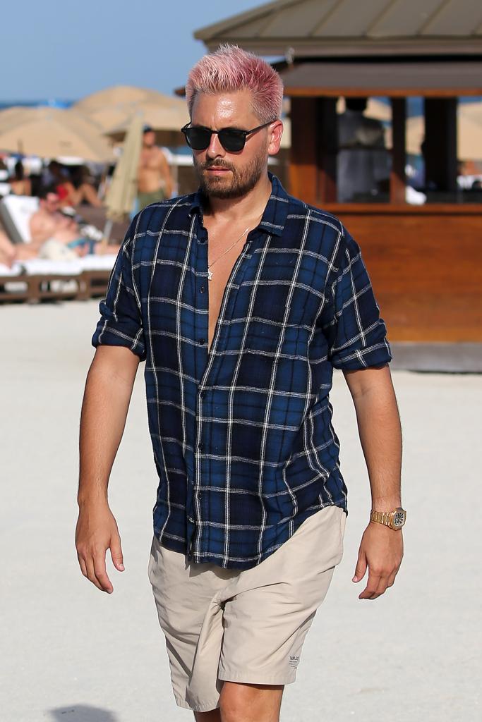 Scott Disick wasn't very beach-ready in his button-up shirt and shorts.