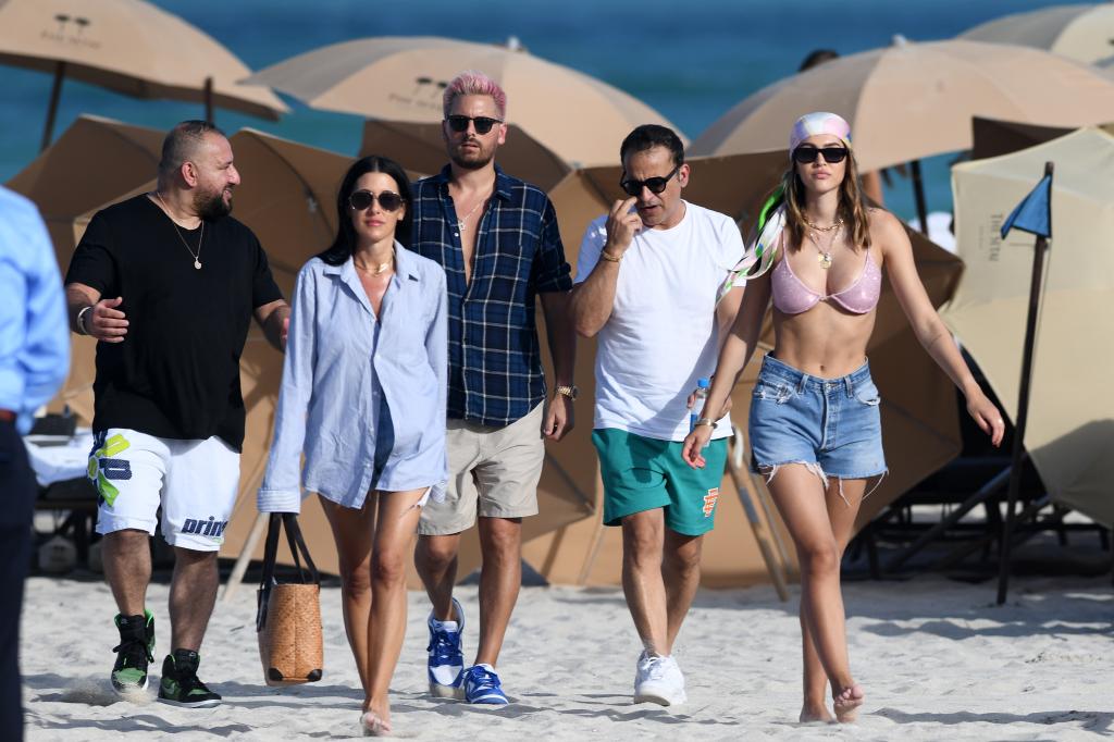 Scott Disick and Amelia Hamlin took a walk along the beach with friends.