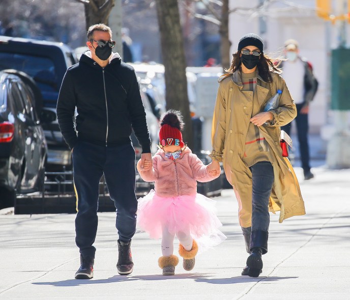 Bradley Cooper and ex Irina Shayk hold hands with daughter Lea as they go for a stroll in New York City.